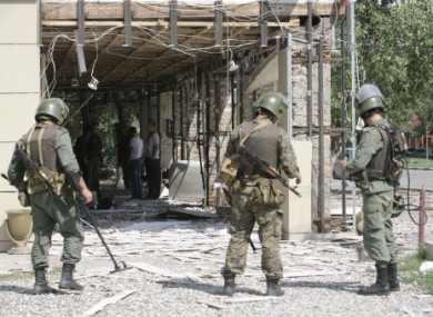 Soldiers examine the blast site outside a cafe in Grozny.