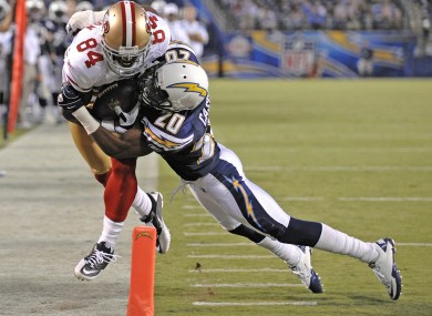 San Francisco 49ers wide receiver Josh Morgan is driven out of bounds by San Diego Chargers defensive back Antoine Cason.