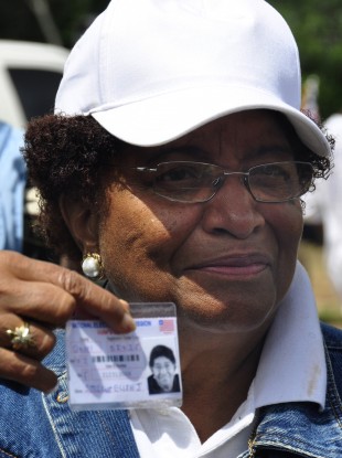 Incumbent president - and Nobel laureate - Ellen Johnson Sirleaf - displays her ID as she queues to vote in Tuesday's first round of balloting.