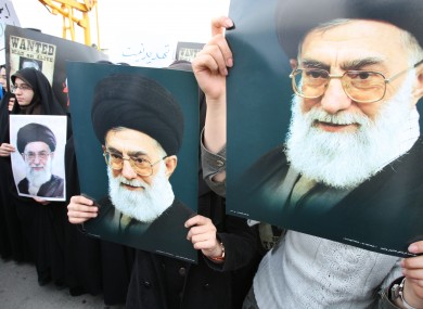 Iranian students hold posters of supreme leader Ayatollah Ali Khamenei