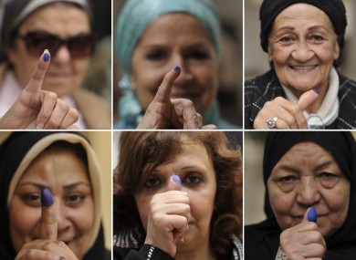 Egyptian women pose with their inked fingers after voting at a polling station in Cairo, Egypt, Tuesday, Nov. 29, 2011