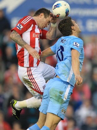 Glenn Whelan and Edin Dzeko challenge for the ball