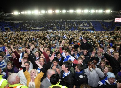 Reading fans celebrate on the pitch.