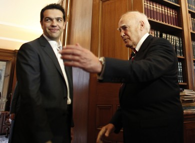 President Karolos Papoulias, right, meets with Syriza leader Alexis Tsipras earlier this week. Papoulias will meet Tsipras again today, as well as the leaders of the two pro-bailout parties, to try and form a unity government.