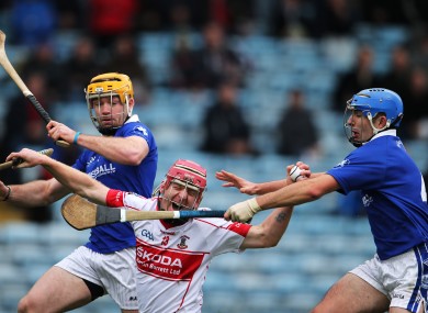 De La Salle's John Mullane under pressure from Padraic Maher and David Maher of Thurles Sarsfields.