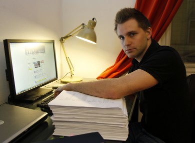Max Schrems sits with files about his activities on his Facebook account that Facebook handed over to him last year.