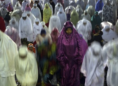 Muslim women perform an evening prayer called