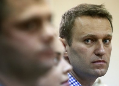 Russian opposition leader Alexei Navalny, right, listens to the judge while attending his trial at a court in Kirov, Russia