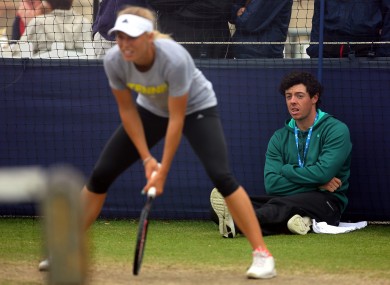 Rory McIlroy watches girlfriend Caroline Wozniacki in practice at the Aegon championships.