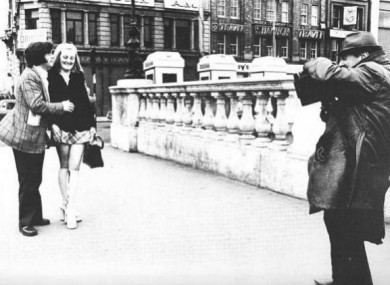 Arthur Fields takes a couple's photo on O'Connell bridge