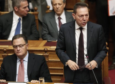 Greece's Finance Minister Yannis Stournaras, right, speaks during a parliament session before he submitted the new draft state budget for 2014.