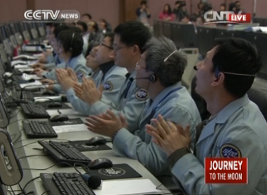 Scientists at the control centre applaud as the spacecraft touches down