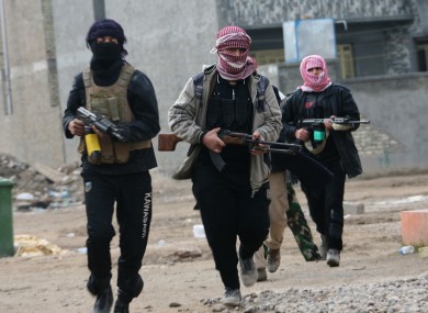 Gunmen patrol during clashes with Iraqi security forces in Fallujah, 40 miles (65 kilometers) west of the Iraqi capital of Baghdad.