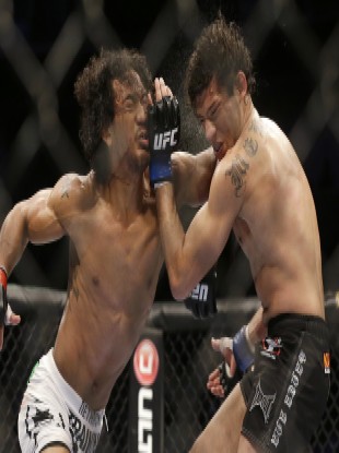 Benson Henderson, left, punches Gilbert Melendez in April.