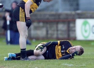 Kieran O'Leary of Crokes checks on the injured Colm Cooper yesterday.