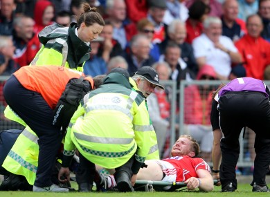 Ruairi Deane is attended to by Cork medics during today's game.